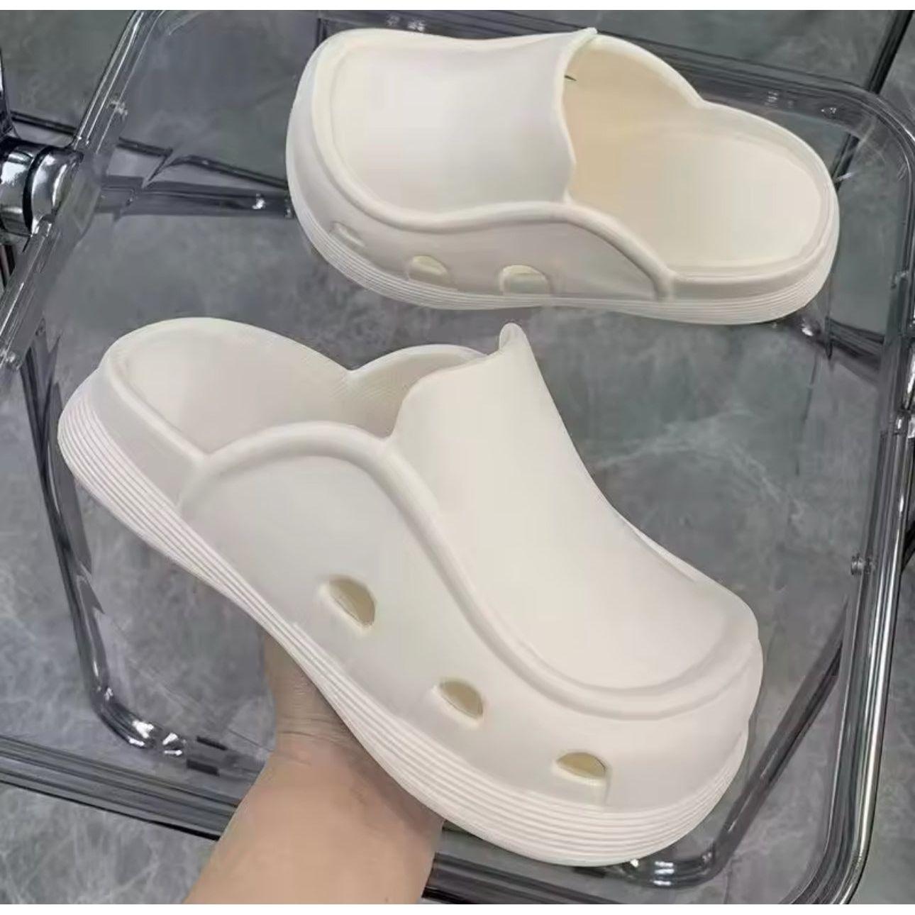 Thick bottom closed toe porous shoes.
