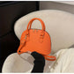 Mini Crocodile Embossed Dome Handbag.