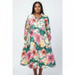 A woman wearing a floral print satin midi shirt dress with long sleeves and standing outdoors.