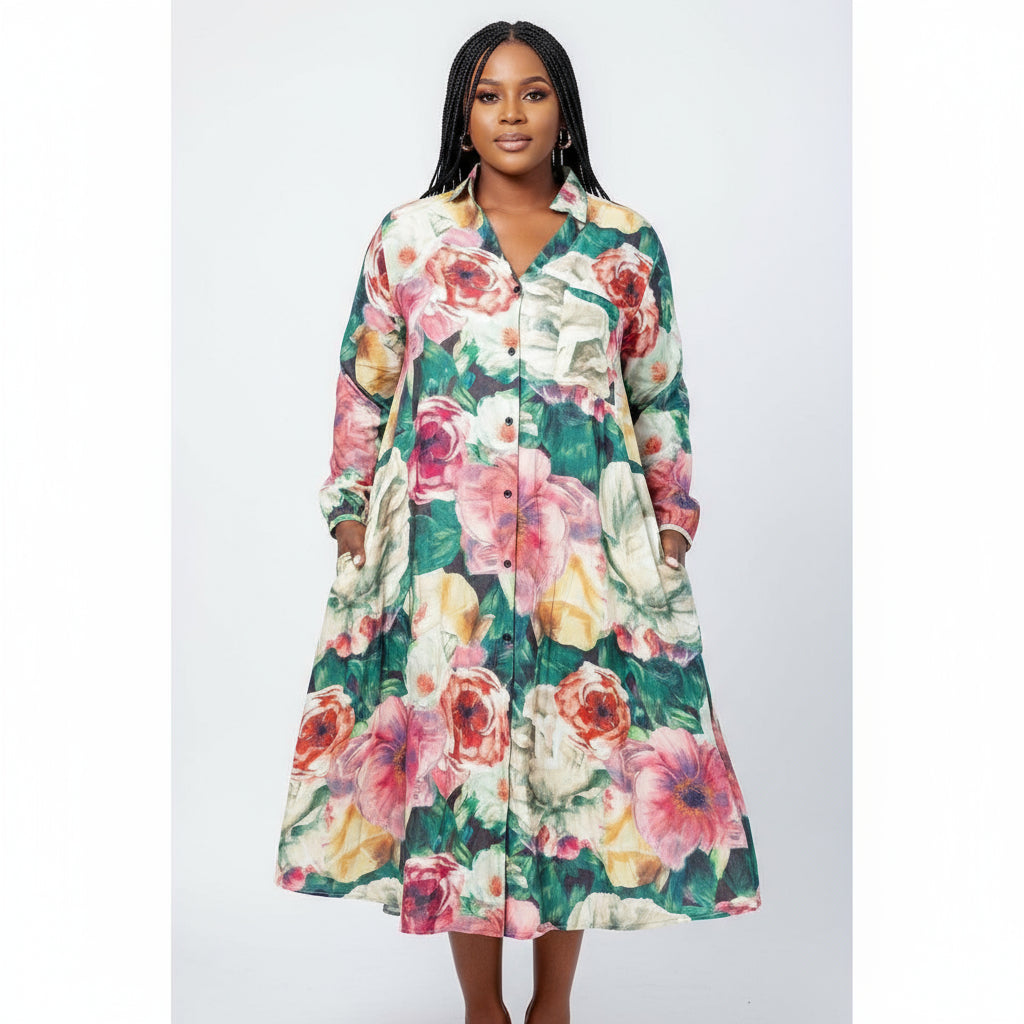 A woman wearing a floral print satin midi shirt dress with long sleeves and standing outdoors.
