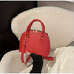 Mini Crocodile Embossed Dome Handbag.