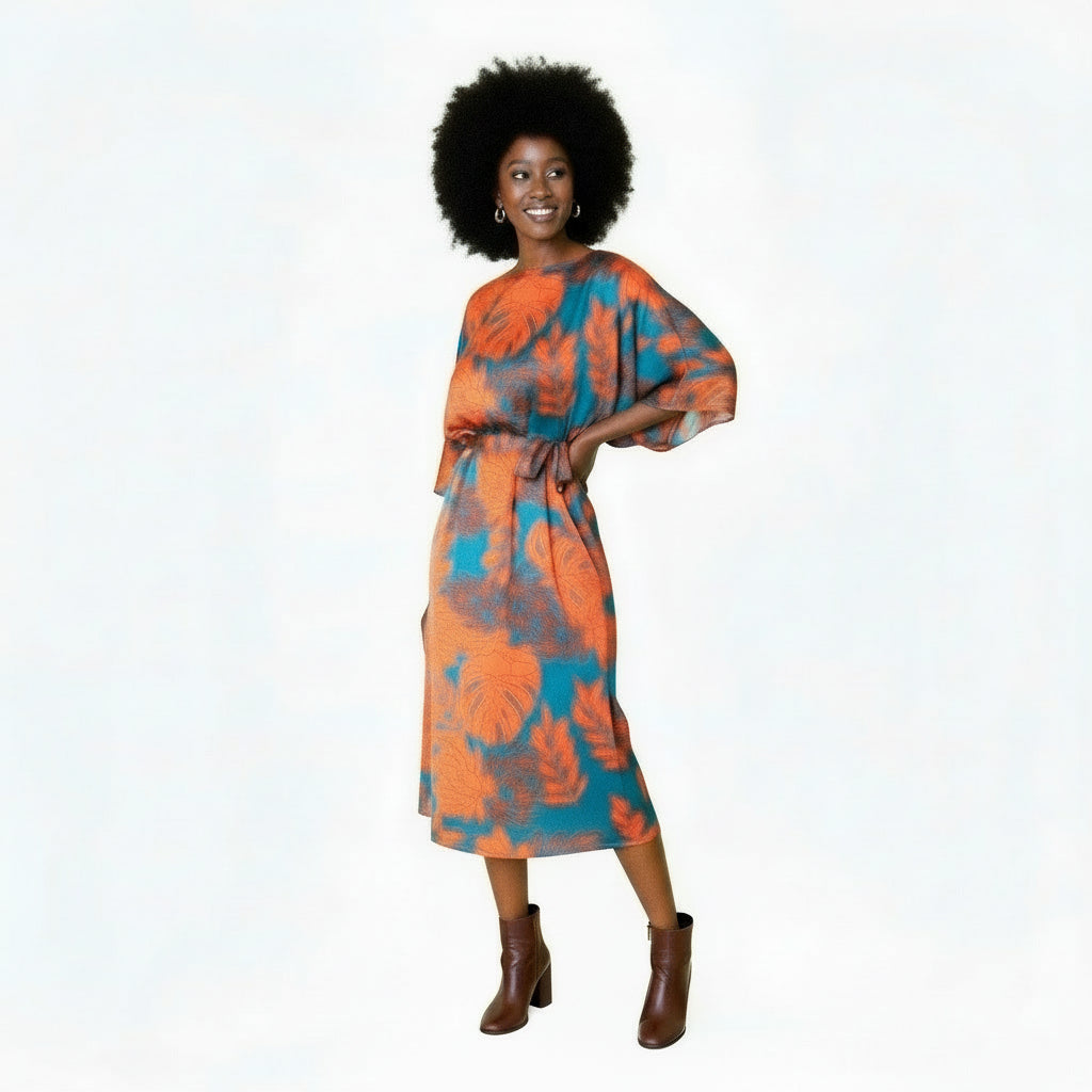 Woman wearing an orange and blue floral dress on a white background