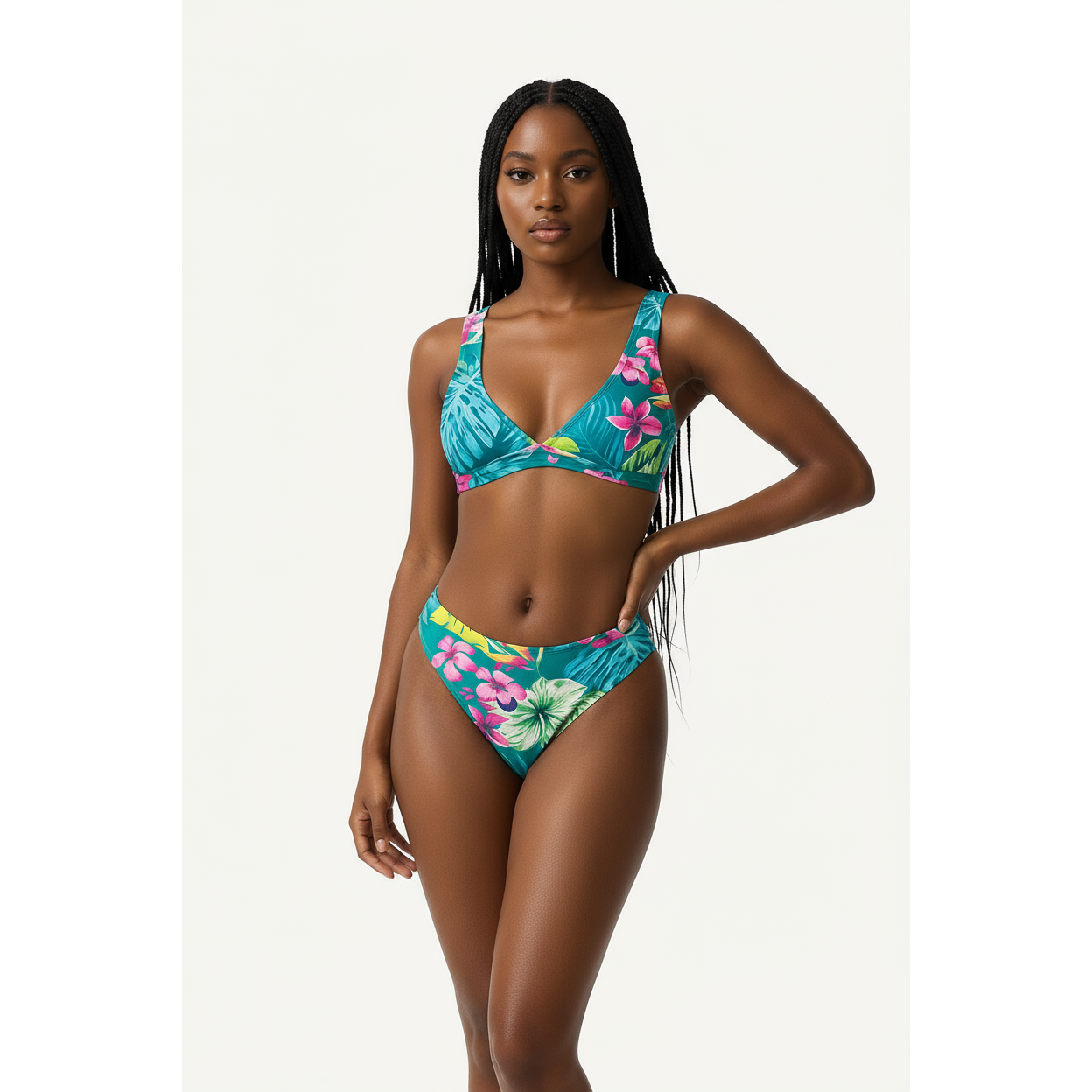 Woman wearing a colorful floral bikini against a white background