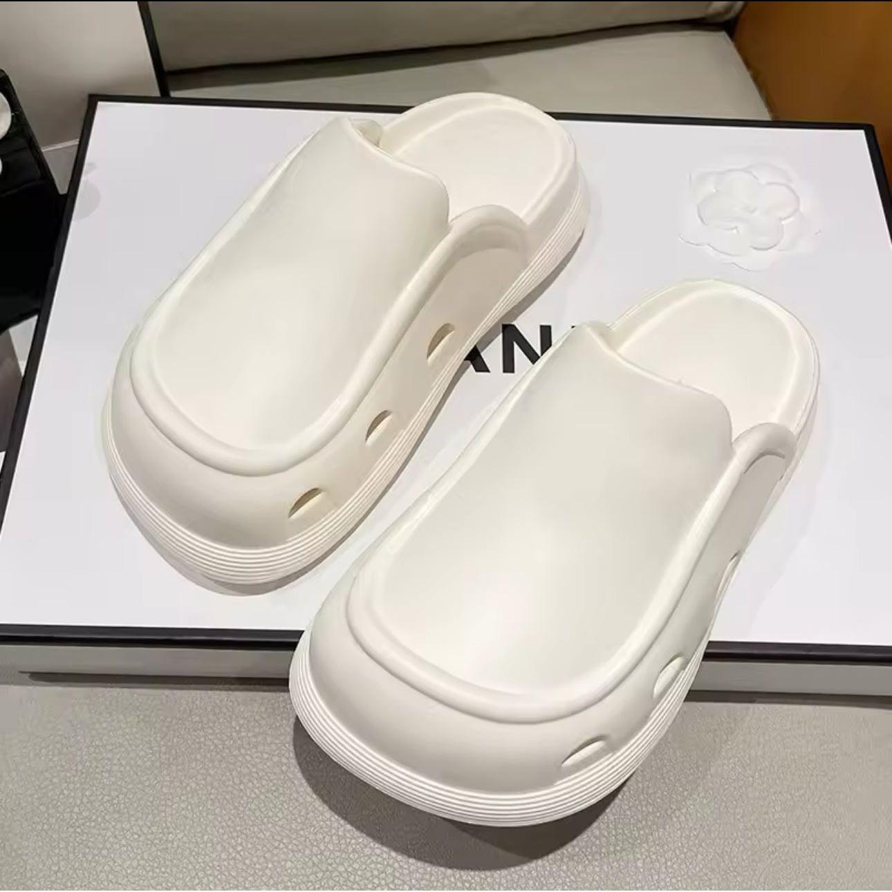 Thick bottom closed toe porous shoes.