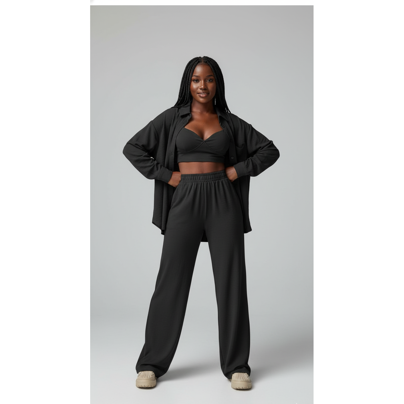 Person wearing a black outfit on a plain background