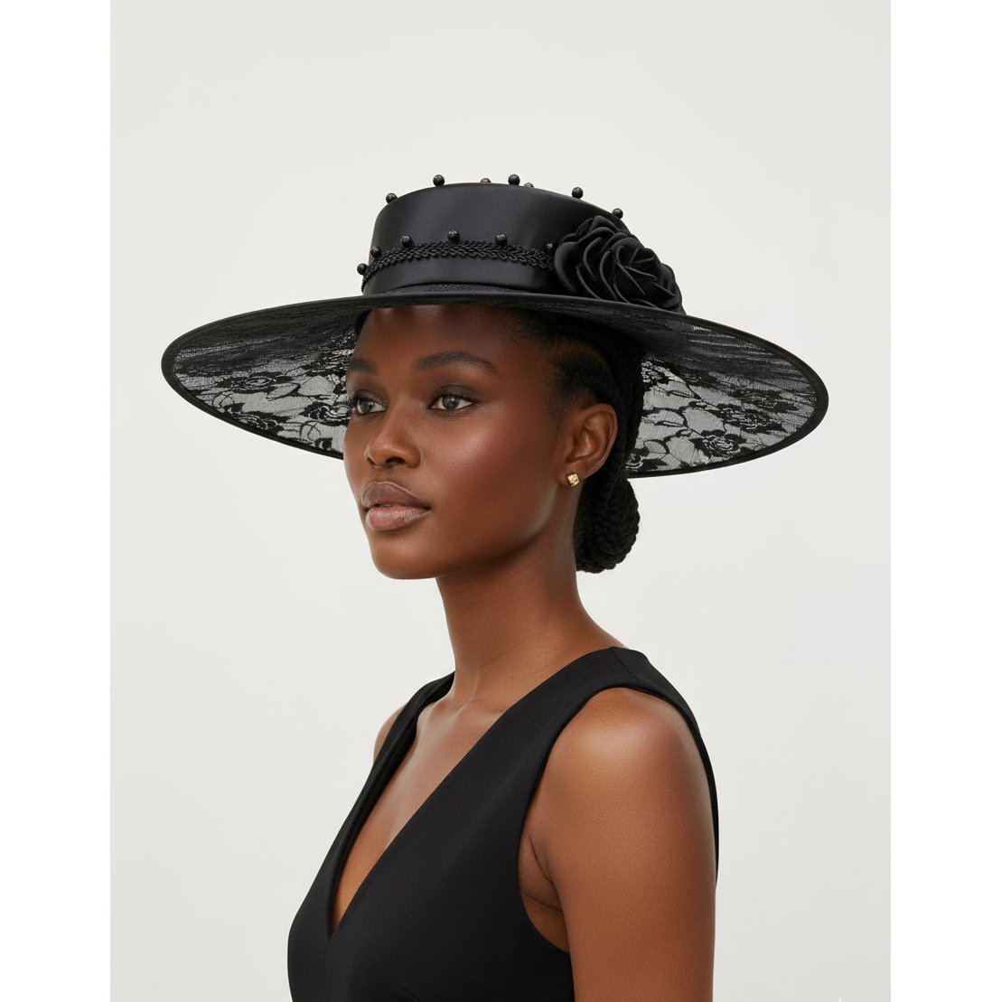 Woman wearing a black lace hat on a white background