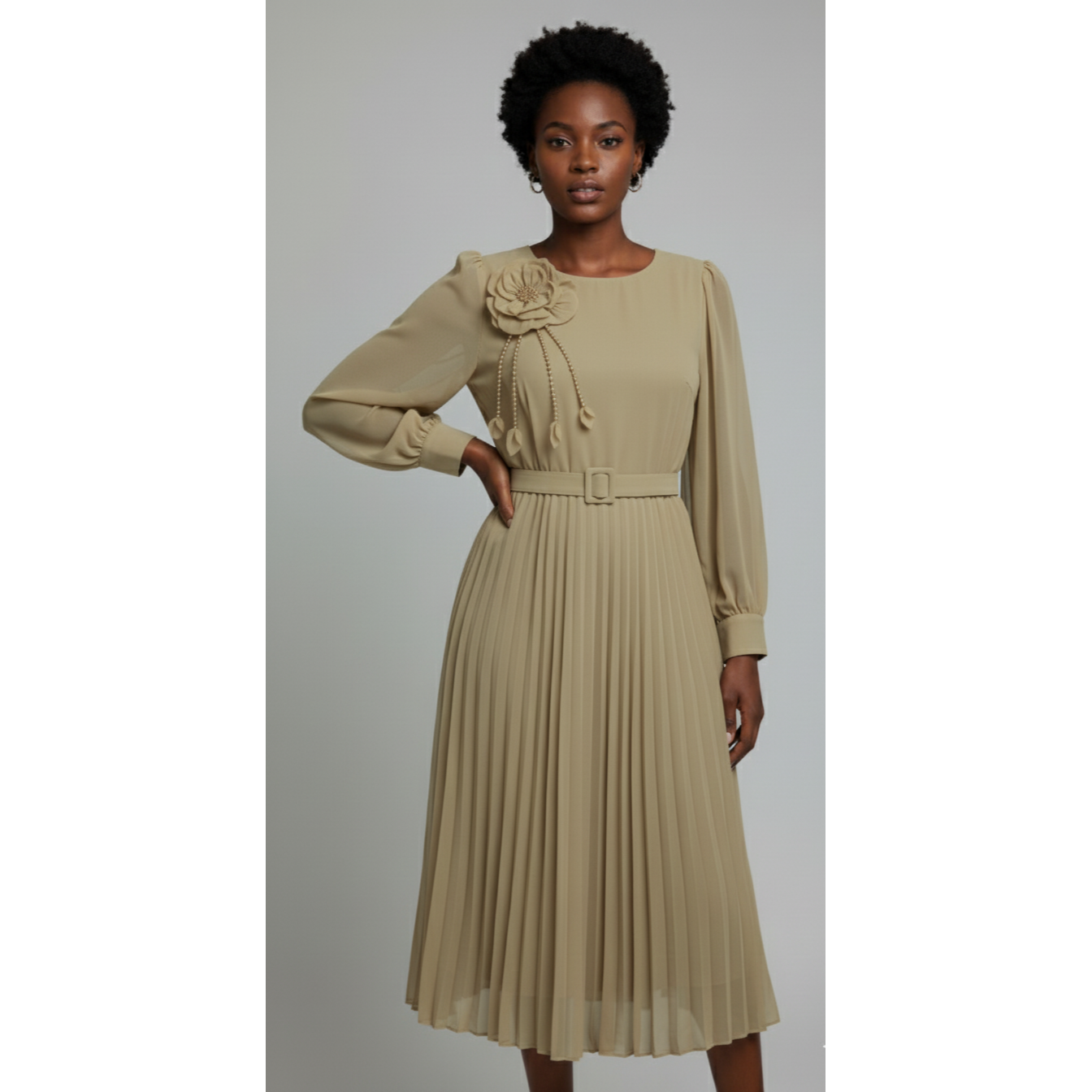 Woman wearing a beige dress with a floral detail on a gray background