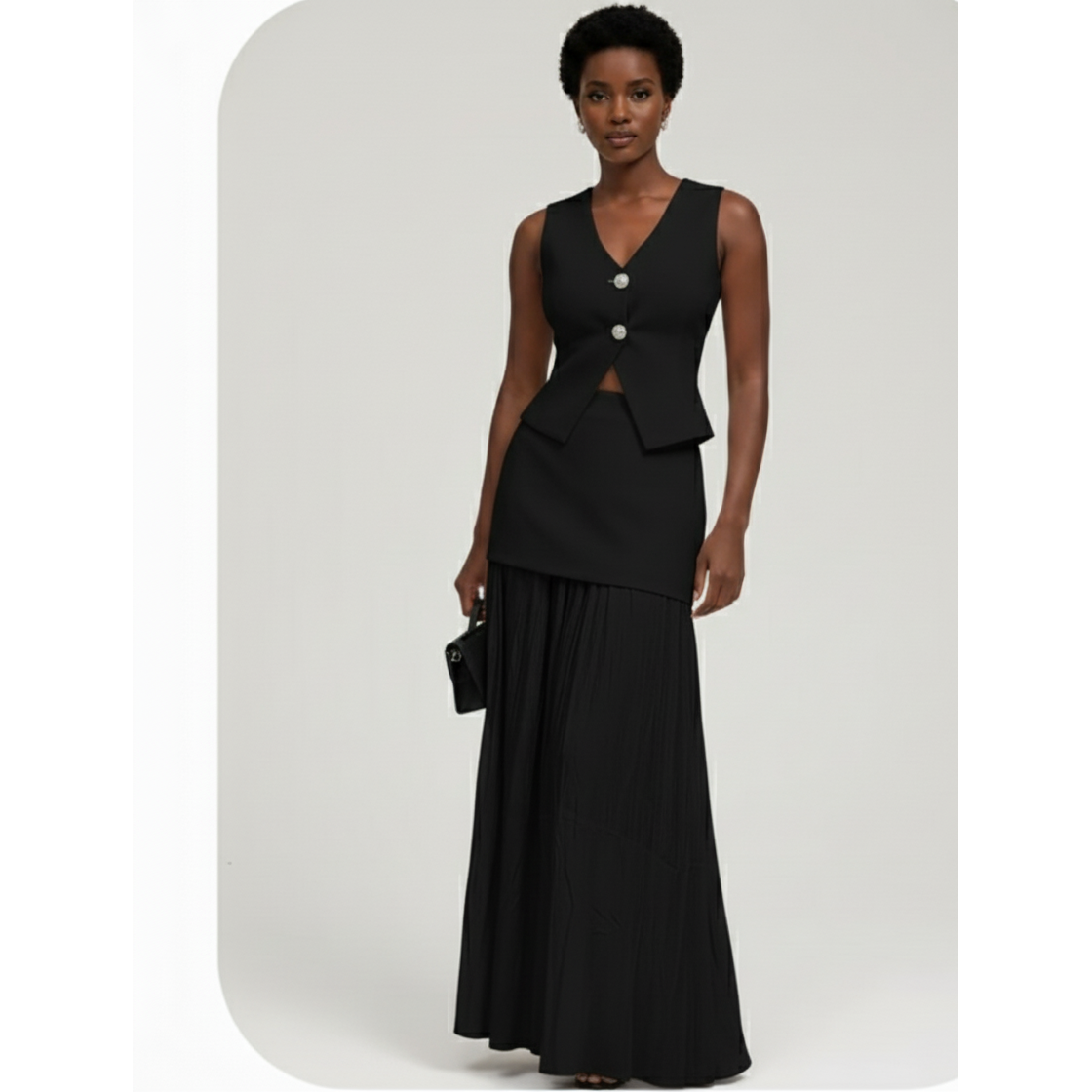 Woman wearing a black sleeveless top and long skirt with buttons on a white background