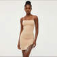 Beige dress on a mannequin against a white background