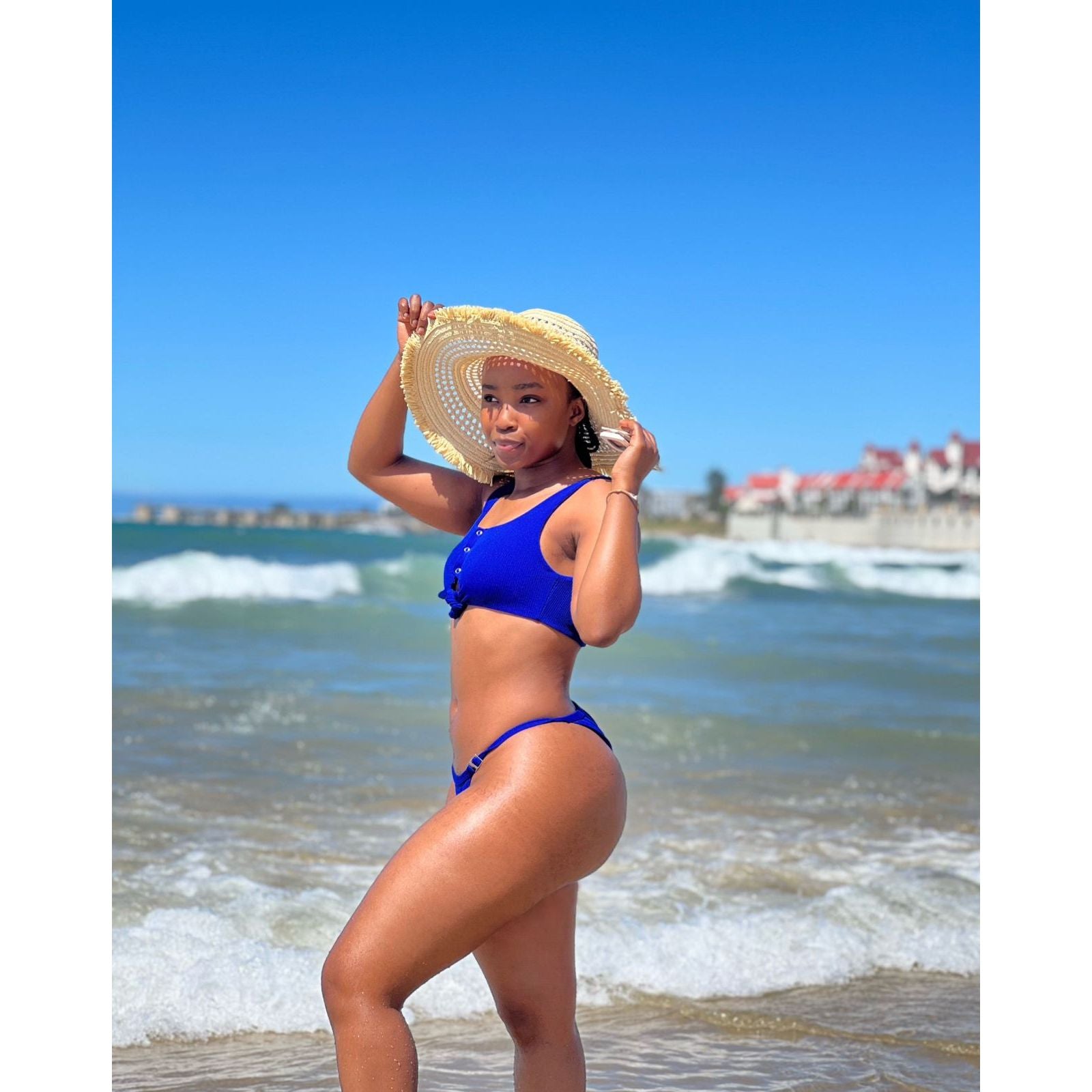 Woman wearing a blue bikini set on a white background