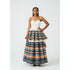 A woman wearing a sleeveless boob-tube dress with a multicolored Ankara print skirt.