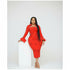 Woman wearing a red dress with bell sleeves against a white background
