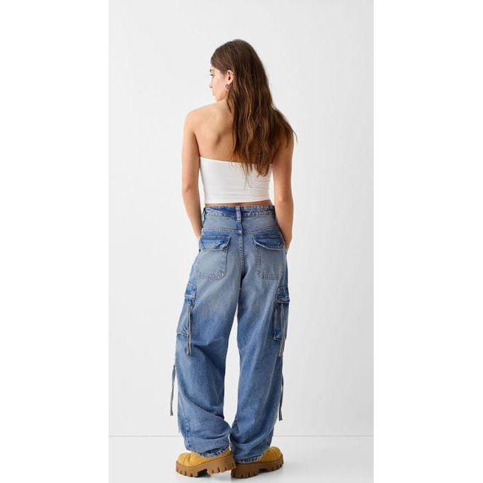 Denim baggy cargo jeans with straps.