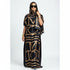 A woman wearing a black and gold printed kaftan abaya African silk maxi dress with a headscarf.