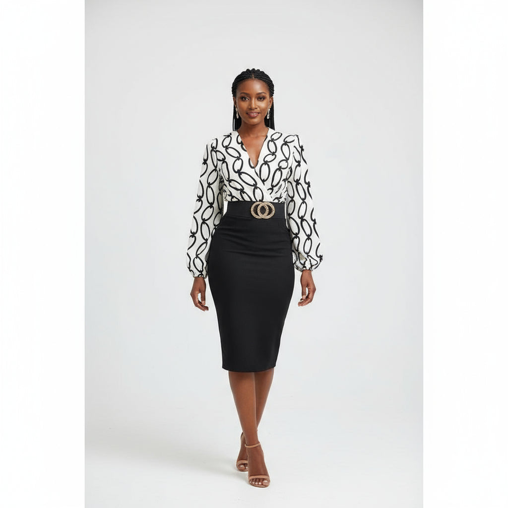 A woman modeling a long sleeve A-line retro midi dress with a black and white floral pattern, paired with a belt, earrings, and a watch.