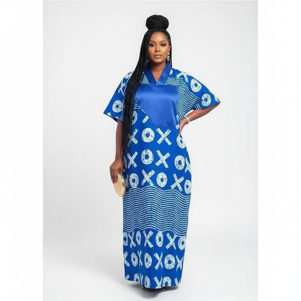 Woman wearing a blue and white patterned dress outdoors.