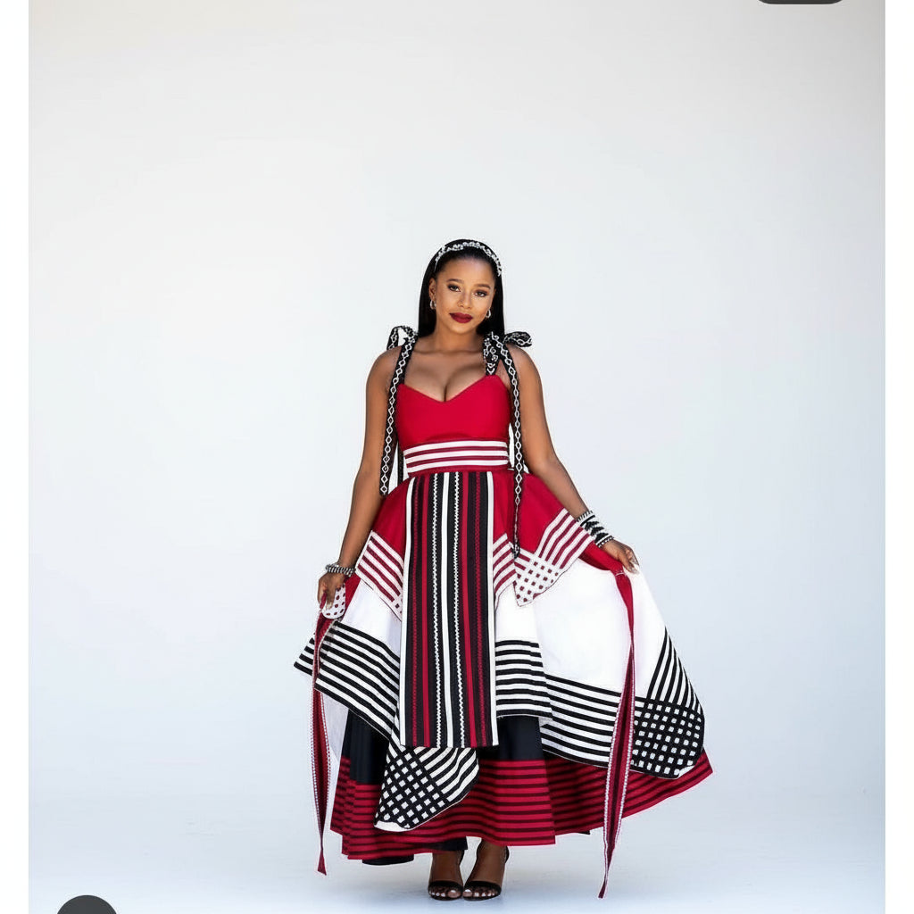 Woman wearing a red, black, and white dress with a patterned design.