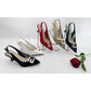 Set of women's high-heeled shoes in various colors with a rose on a white background