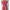 Person wearing a bright pink lingerie set with chains on a textured white background