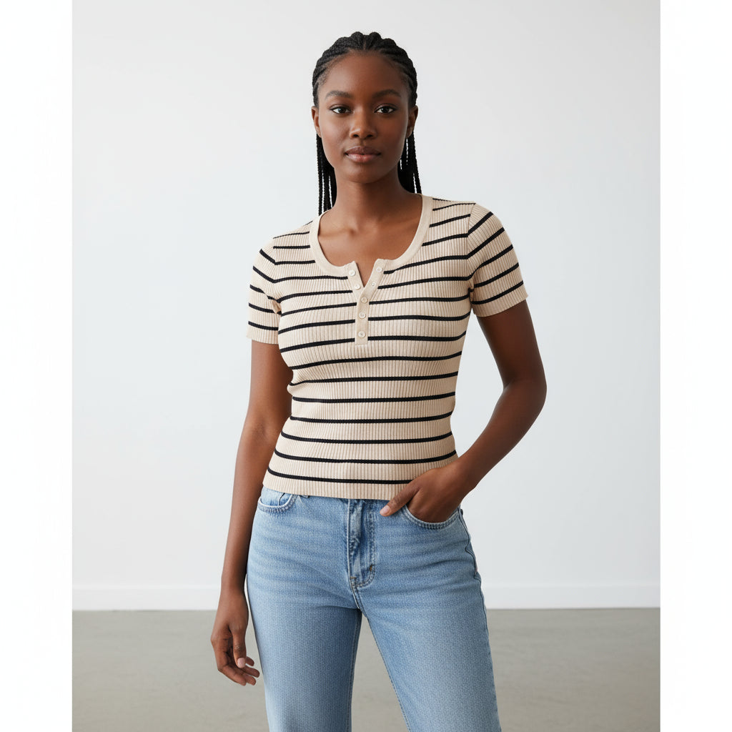 Person wearing a striped shirt and jeans taking a mirror selfie in a store.