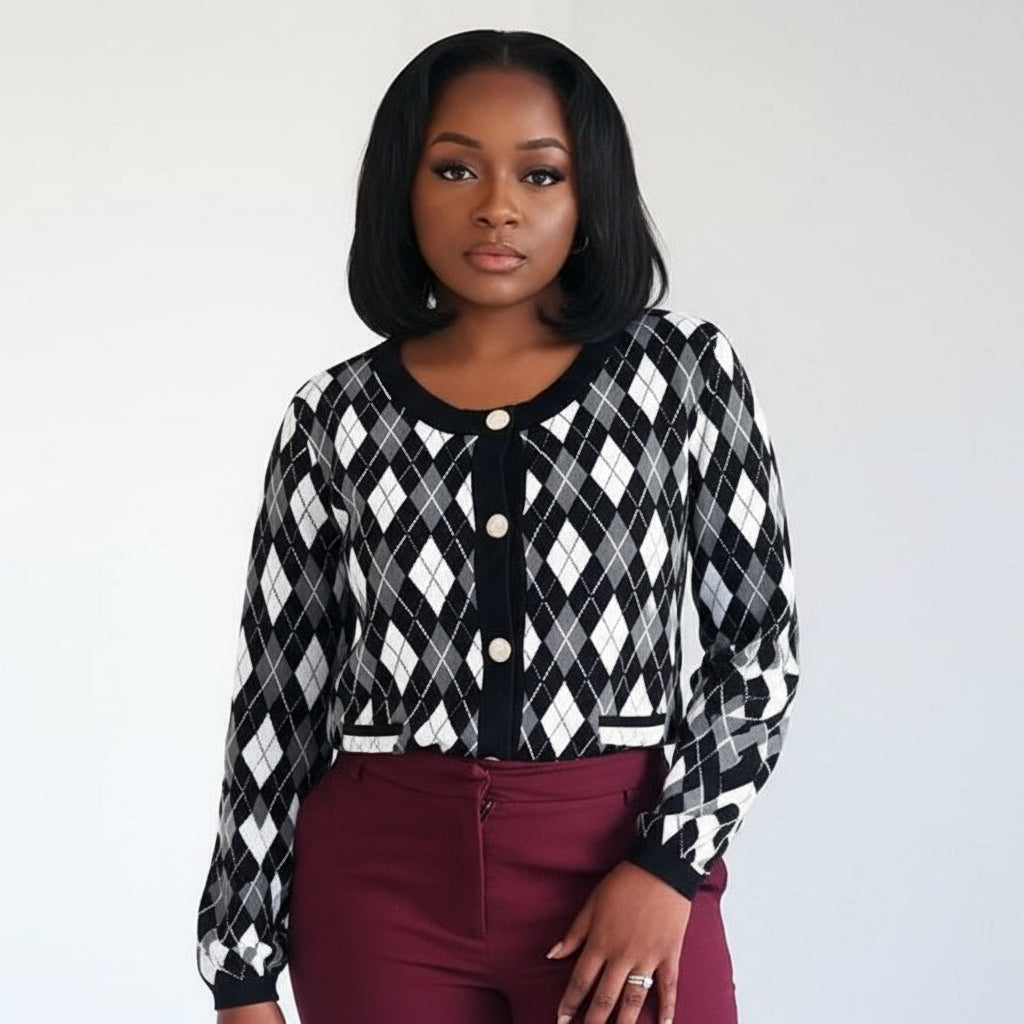 Woman wearing a black and white checkered cardigan with a plain background