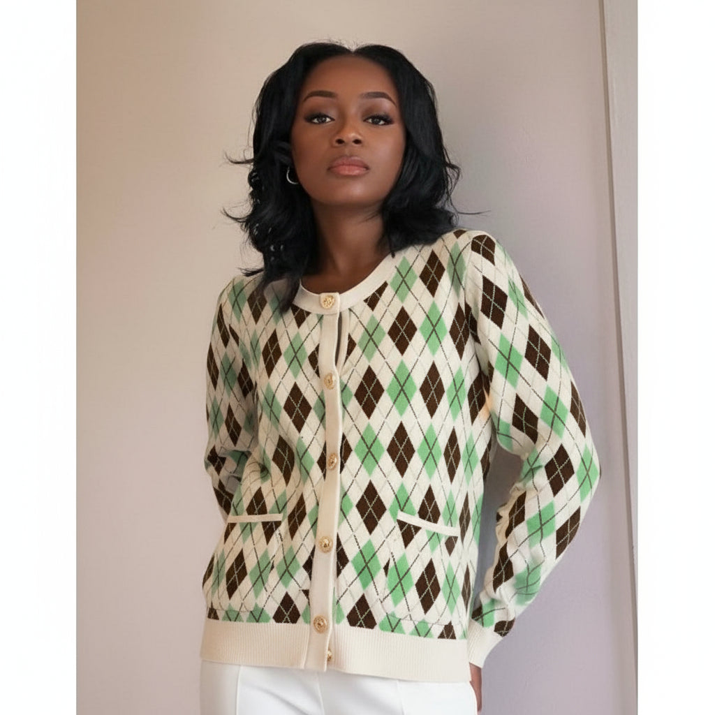 Woman wearing a green and brown argyle patterned cardigan against a plain background