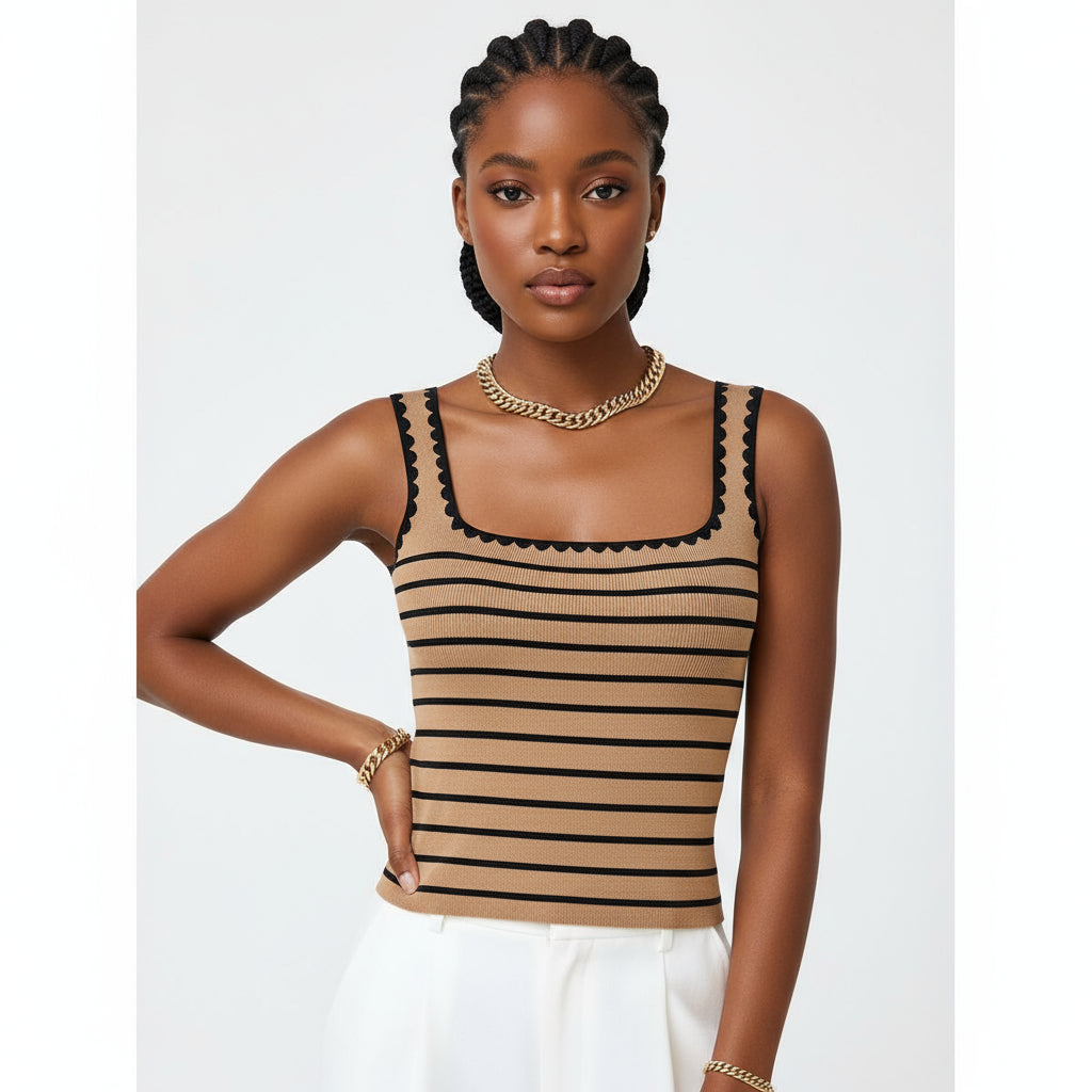 Woman wearing a brown and black striped tank top with a gold chain necklace against a light background