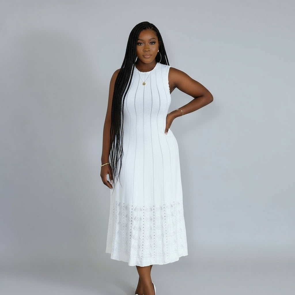 Woman wearing a white dress against a plain background