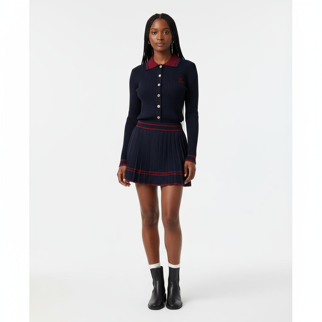 Person wearing a navy dress with red accents in a living room setting