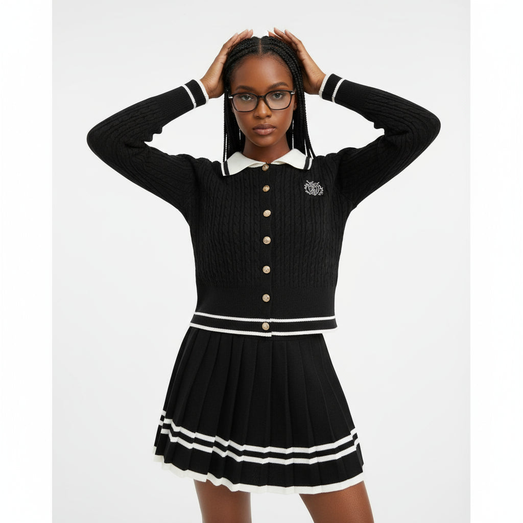 Woman wearing a black sweater with white trim and a matching skirt against a gray background