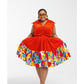Woman wearing a bright orange dress with a colorful floral skirt on a white background