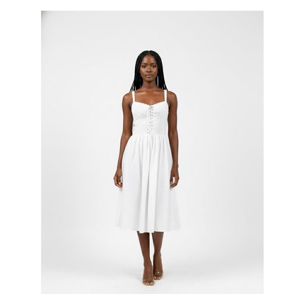 Woman wearing a white dress on a plain background