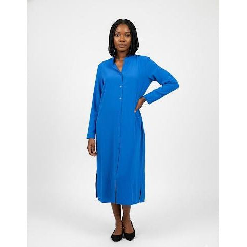 Woman wearing a blue dress against a white background