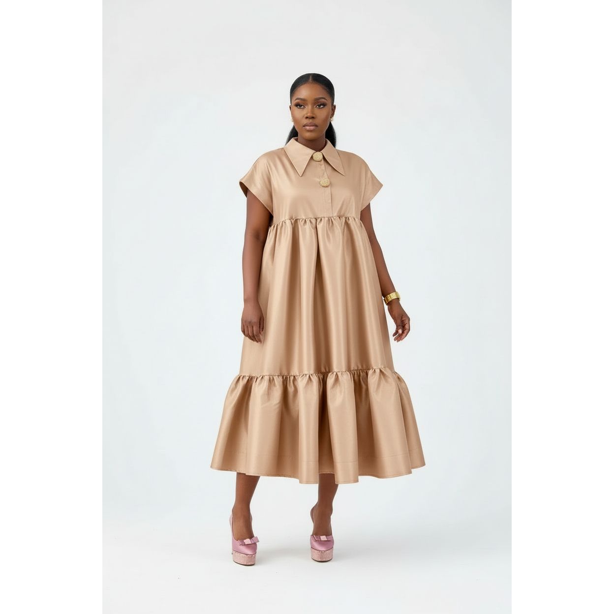 Woman wearing a beige dress on a white background