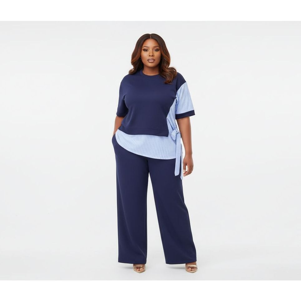 Woman wearing a navy outfit with a light blue top on a white background