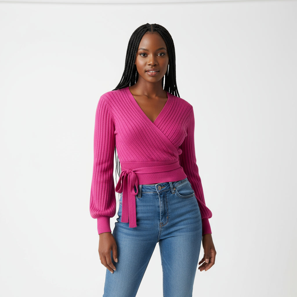 A woman wearing a purple knitted V-neck top with long sleeves and a self-tie belt at the waist, paired with blue jeans.