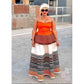A woman wearing a BoobTube xhosa African print dress with a strapless orange top and a long skirt featuring geometric patterns.
