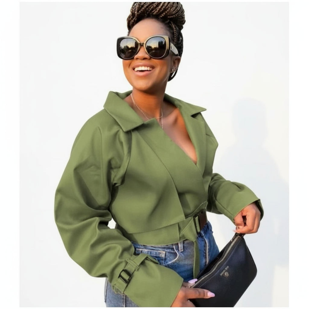 A woman wearing a green lapel neck crop jacket paired with blue denim jeans.