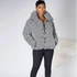Person wearing a houndstooth pattern jacket on a white background