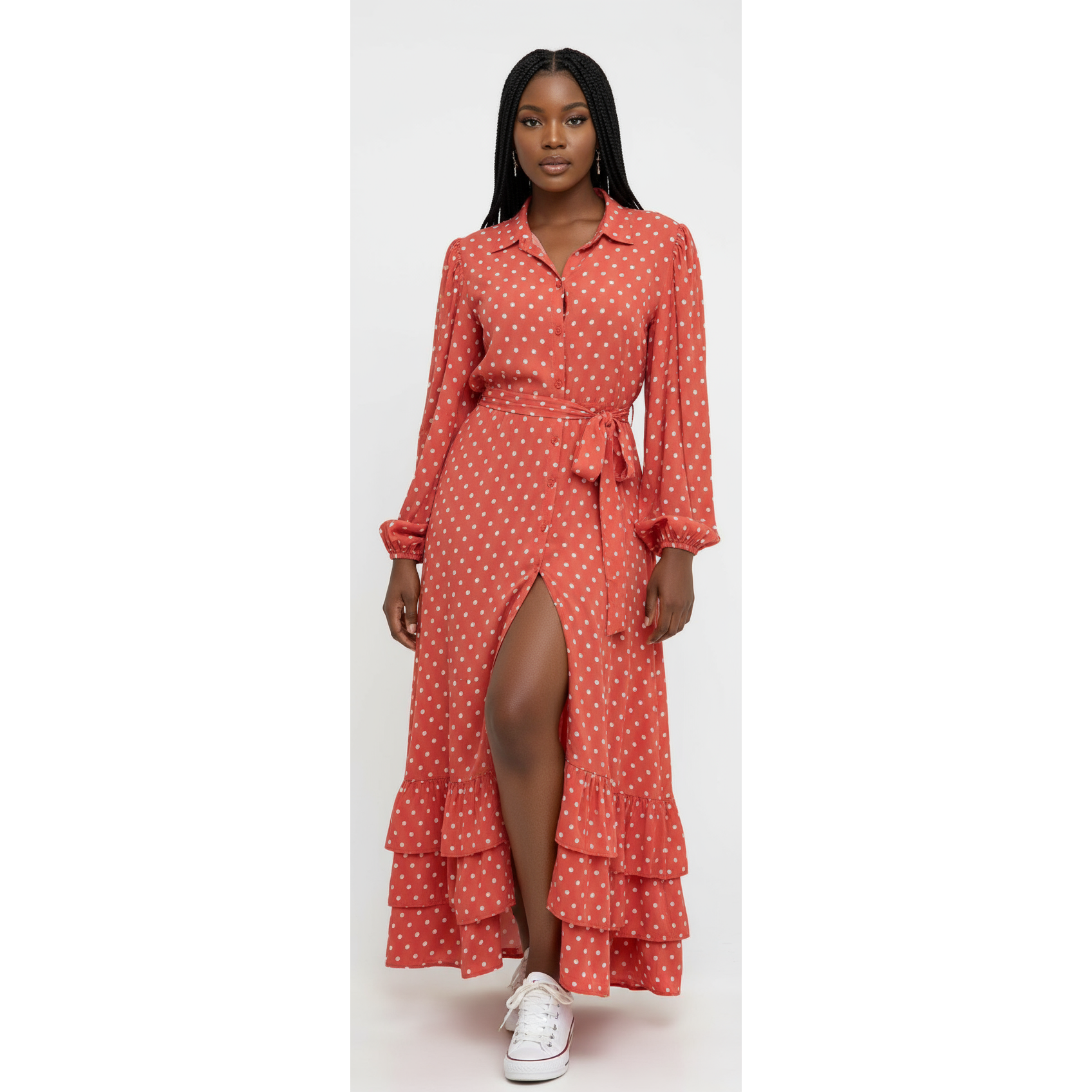 Woman wearing a red polka dot dress with a white background
