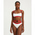 A two-piece swimsuit with red and white patchwork bandage straps