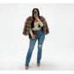 Person wearing a fur coat and jeans on a white background