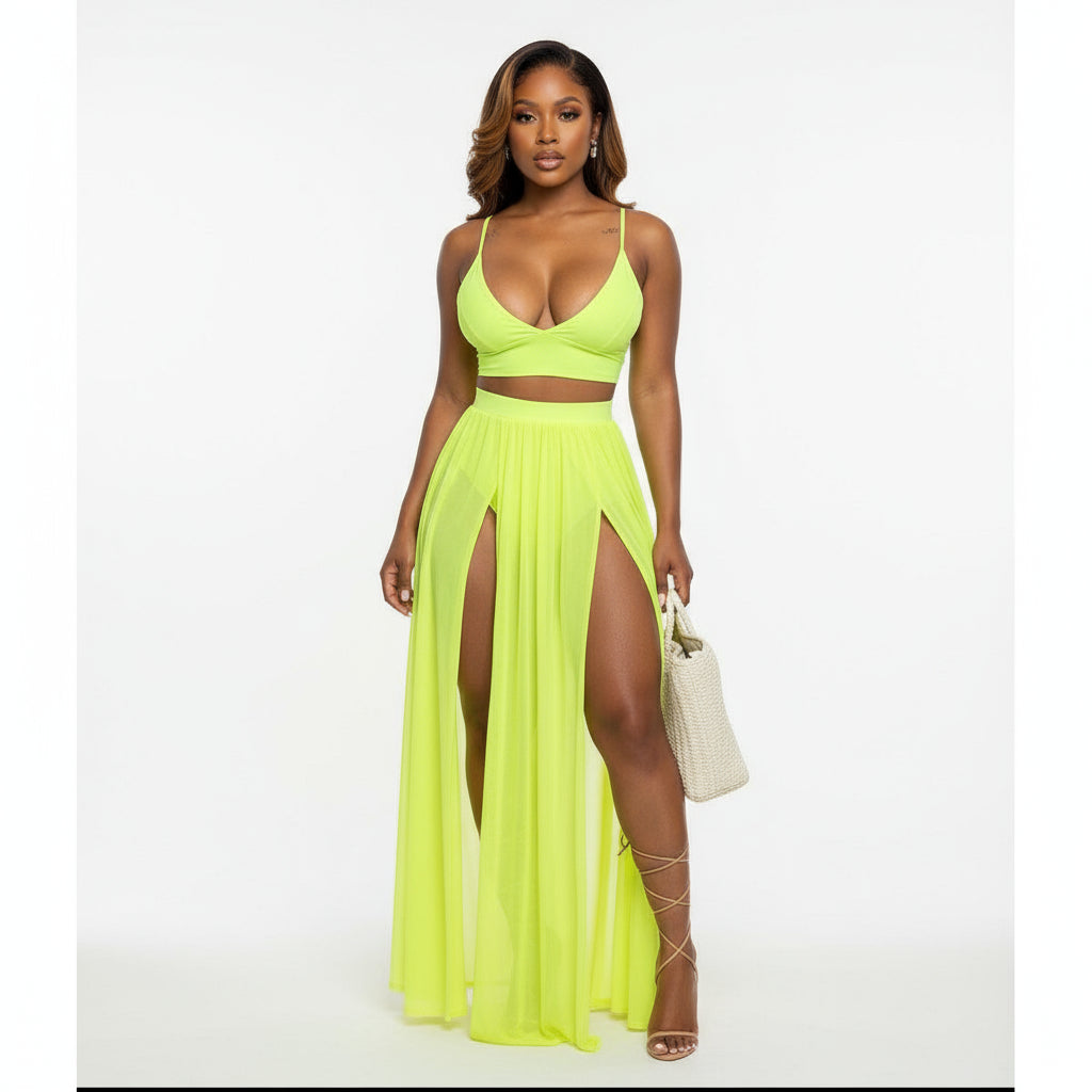 Woman wearing a bright yellow dress with a high slit on a white background