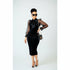 A woman wearing a black bodycon dress with 3/4 length sleeves, paired with sunglasses and a Louis Vuitton bag, standing in a public area.