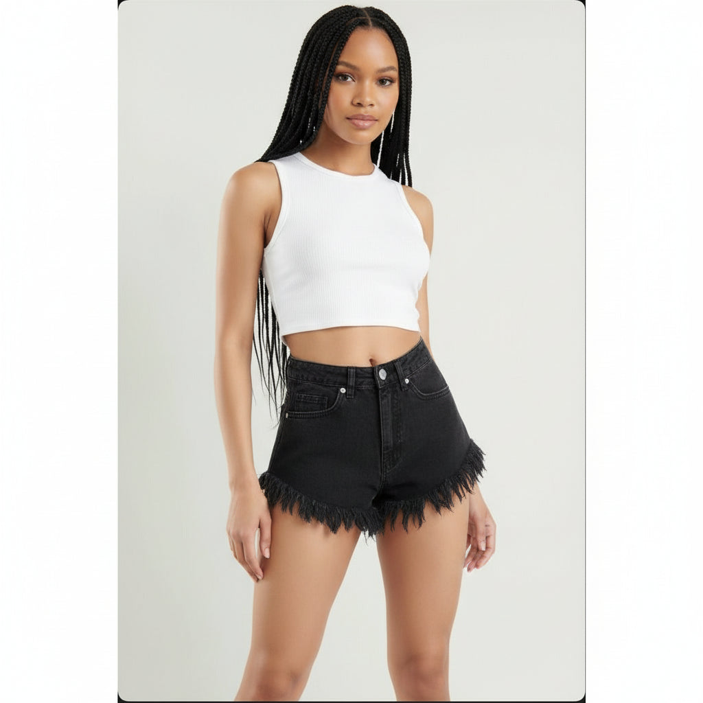 A pair of distressed black denim shorts with frayed hem, paired with a white top, against a white background.