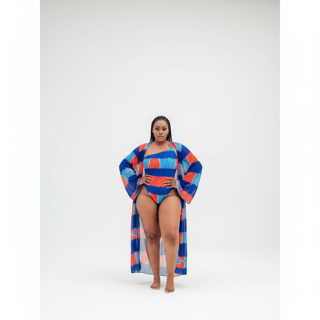 A person standing by a pool wearing a multicolored swimsuit and a matching see-through long kimono.